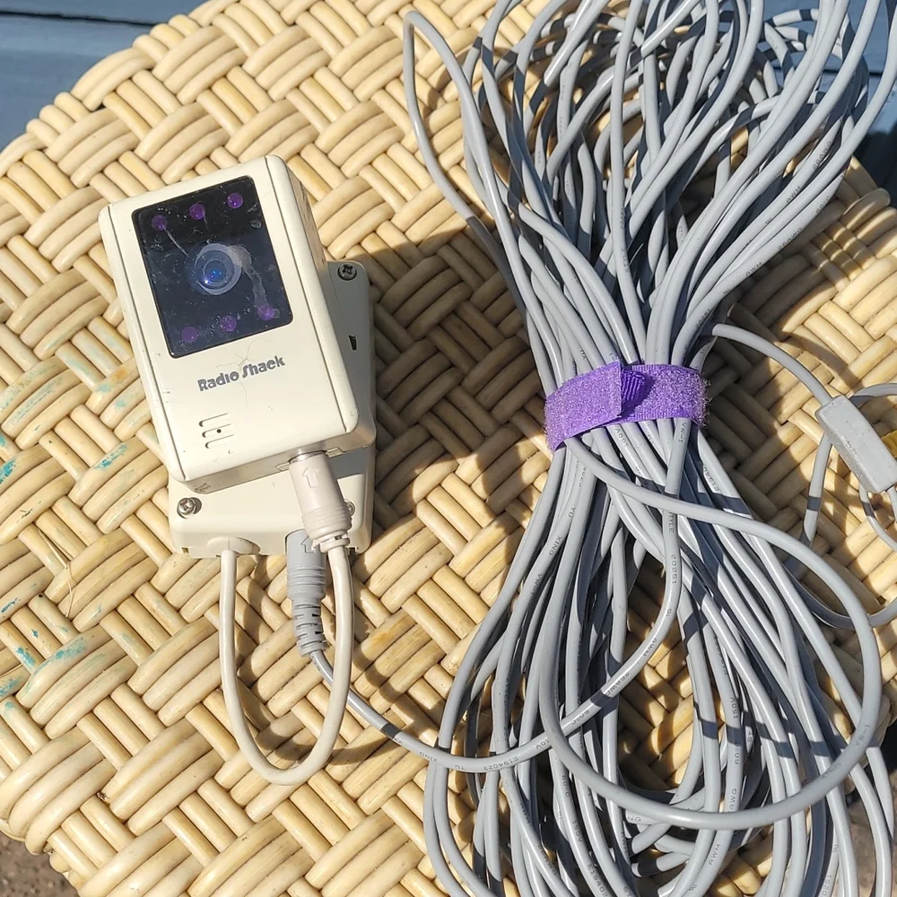 Old radio shack outdoor camera with video and power cord.